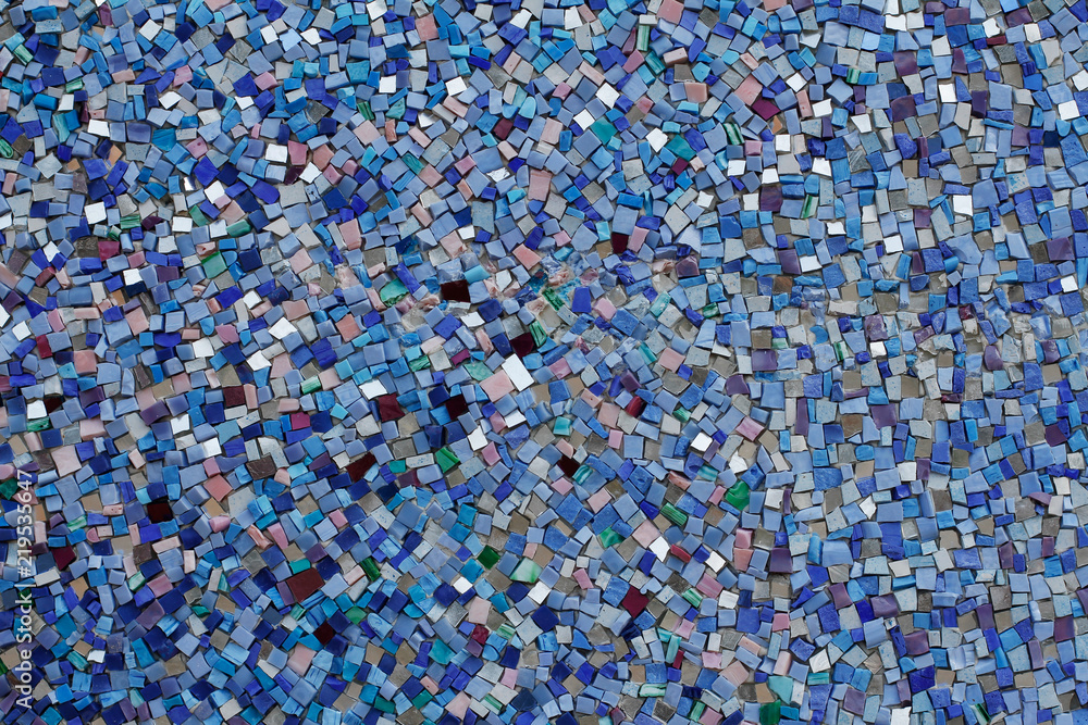 Colorful (blue, green, white and purple) stone mosaic tiles on the wall as background or texture