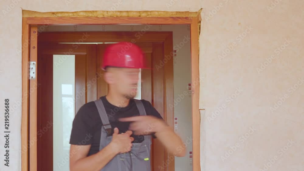 Upset, unhappy man working with laptop and blueprints at his new home Upset, unhappy man working with laptop and blueprints at his new home