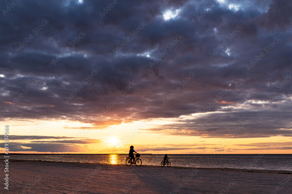 Silhouette of mom and baby on a bicycle