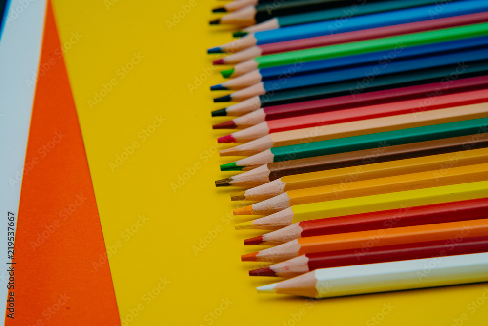 Color pencils on yellow background. Close up. Texture wood. Color pencils on yellow background. Close up. Texture wood.