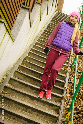 Woman wearing sportswear exercising outside during autumn © Voyagerix
