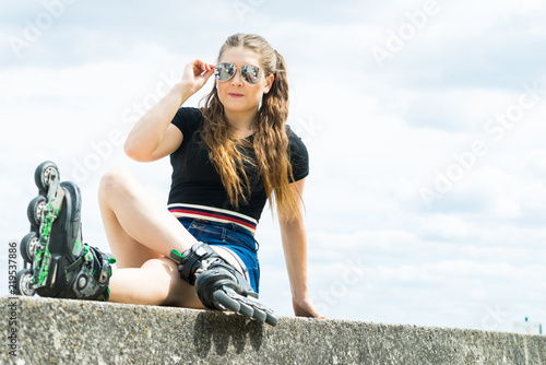 Fit girl with roller skates outdoor © Voyagerix
