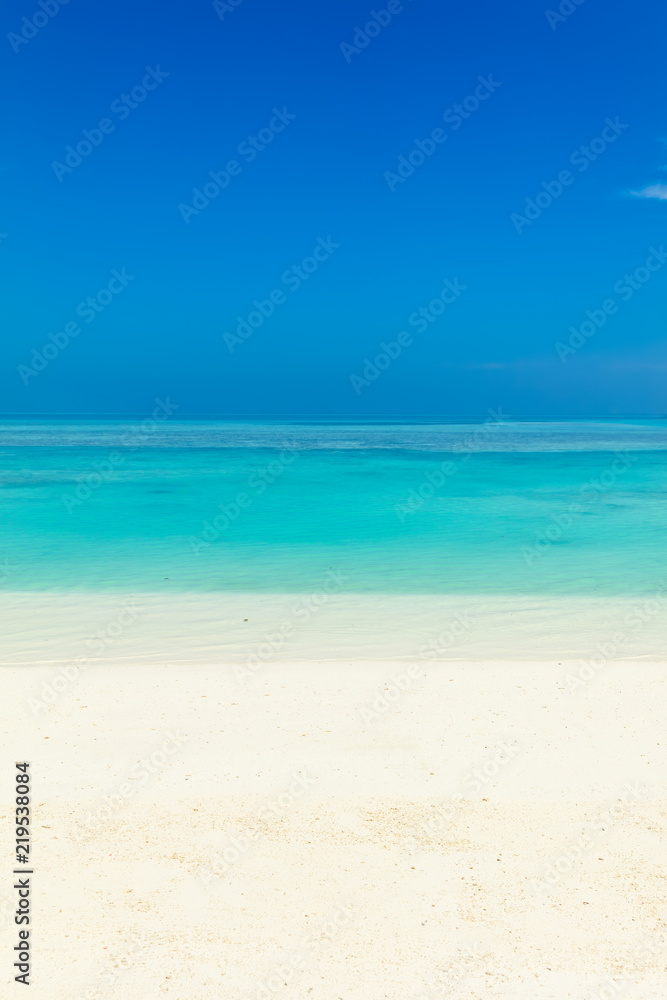 Blue sea water surface, clear sky and sandy seashore
