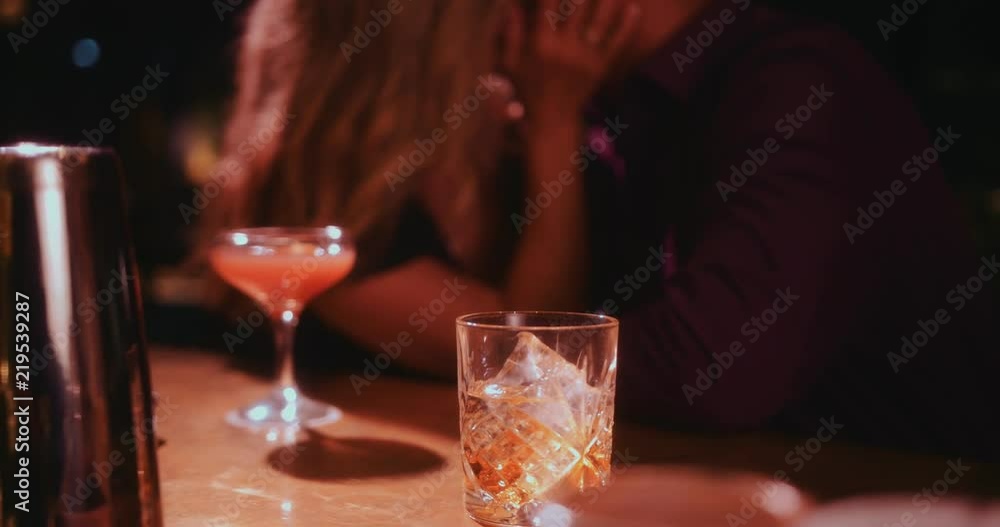 Couple on date night sitting on bar counter and kissing Couple on date night sitting on bar counter and kissing