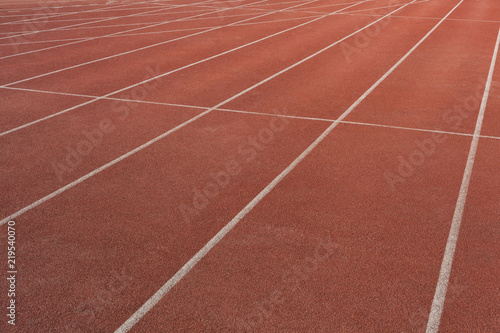 Numbers on the track is the finish pointred running track on athletic stadium background texture © Tjeerd