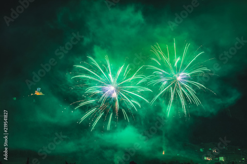 Wonderful couple of green fireworks on the feast of the patron saint of the city whose church is visible in the background, Vittorio Veneto, Italy