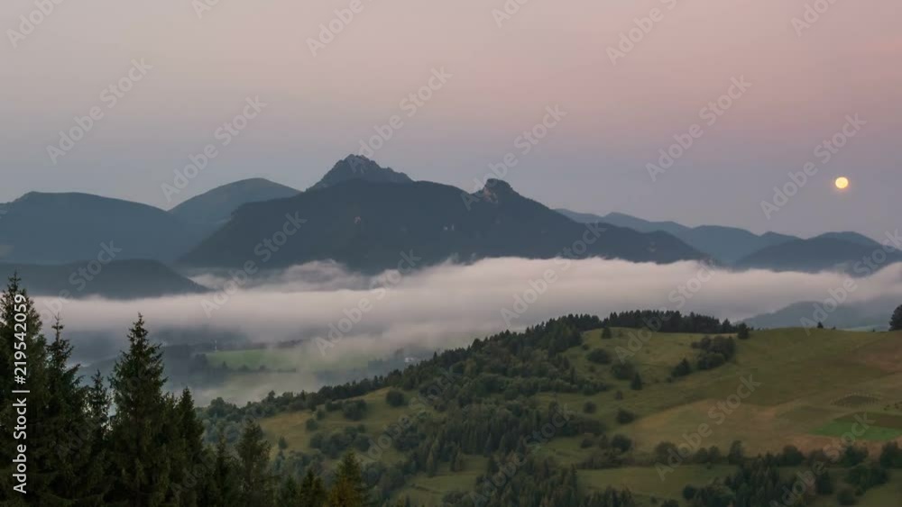 Moon set dawn at sunrise in foggy mountains landscape Time lapse Moon set dawn at sunrise in foggy mountains landscape Time lapse