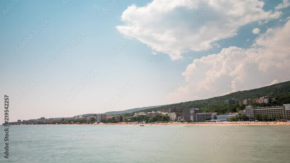 PANNING UP Timelapse of beautiful beach resort in Europe with people on the beach having fun PANNING UP Timelapse of beautiful beach resort in Europe with people on the beach having fun