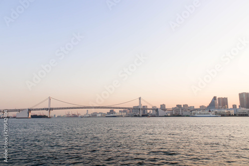One boat and rainbow bridge at sumida river viewpoint in tokyo