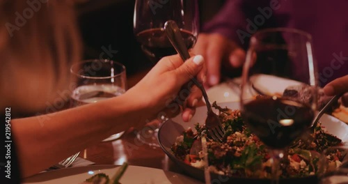 Close-up of people eating gourmet quinoa salad at luxurious restaurant