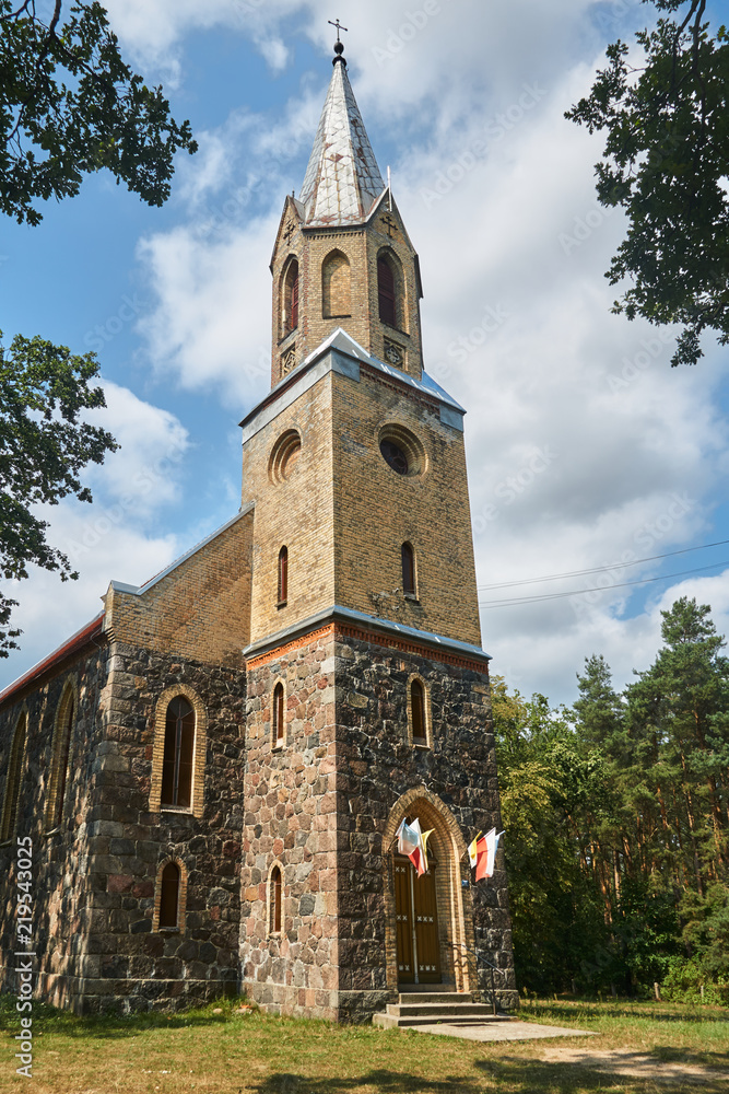 Neo-Gothic, historic parish church with a tower in Poland.