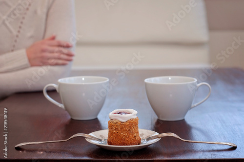 Waiting for someone in a caf e on a table for 2  Runeberg s cake or tart is a Finnish traditional dessert and pastry