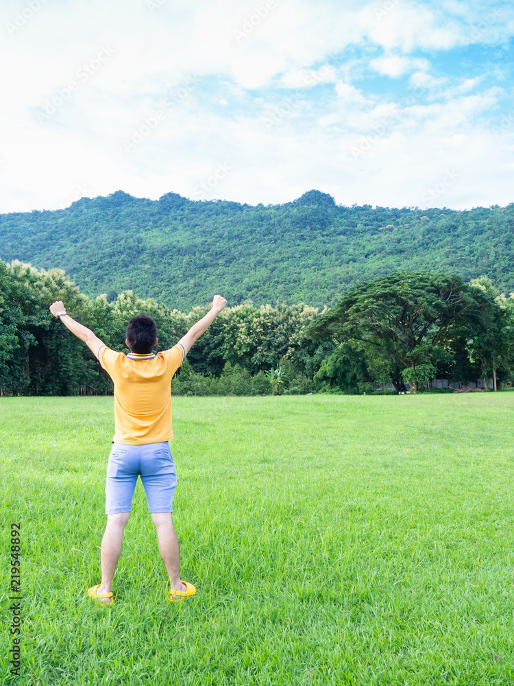 Happy of man standing alone with arms raised up during beautiful forest. Enjoying with nature. Happy of man standing alone with arms raised up during beautiful forest. Enjoying with nature.