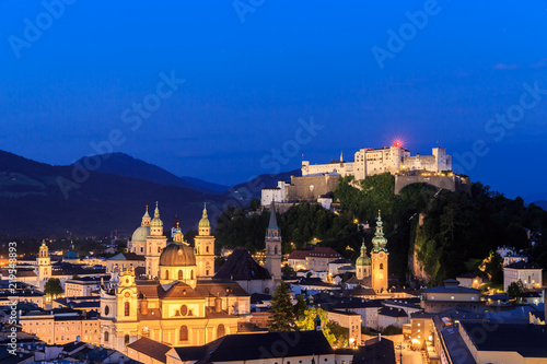 Salzburg Cathedral and famous Festung Hohensalzburg illuminated in twilight