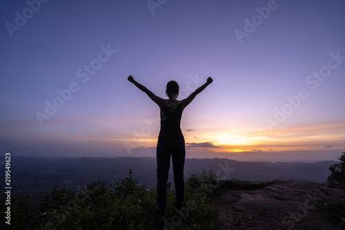 Woman successful hiking climbing silhouette in mountains © pigprox