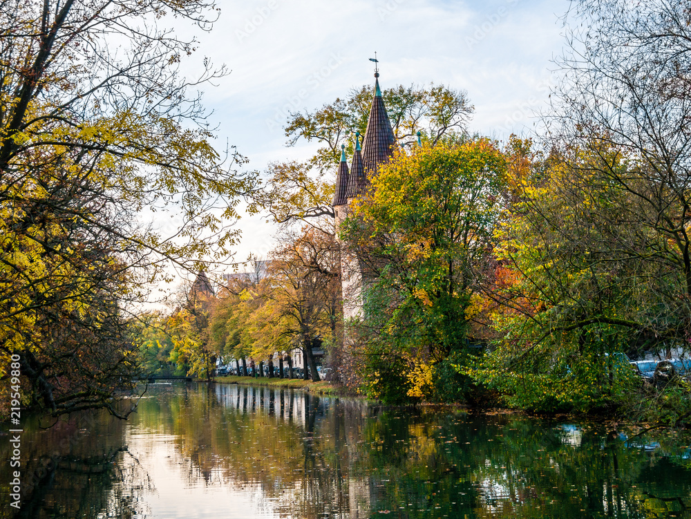 View on tower in Augsburg during autumn with water reflections View on tower in Augsburg during autumn with water reflections