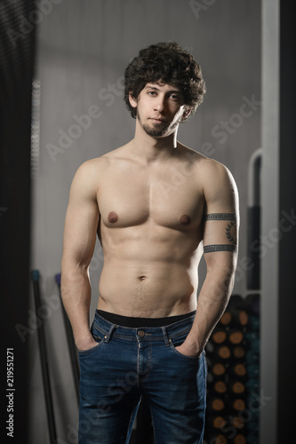 Wallpaper Mural Young attractive man resting in gym after exercising, male posing Torontodigital.ca