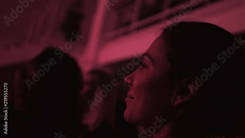 A girl at a concert of a favorite band in a crowd, a party in a nightclub