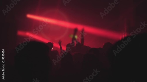 A crowd of people dancing at a music festival. A party in the big hall
