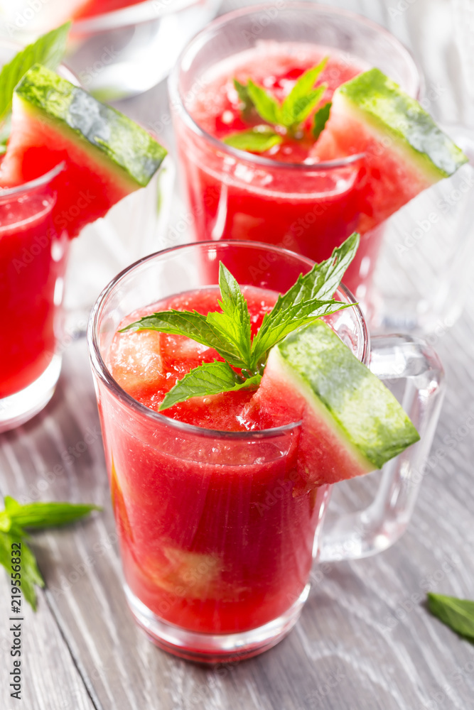 Watermelon drink in glasses with slices of watermelon and mint leaves Watermelon drink in glasses with slices of watermelon and mint leaves