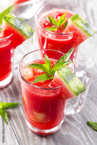 Watermelon drink in glasses with slices of watermelon and mint leaves