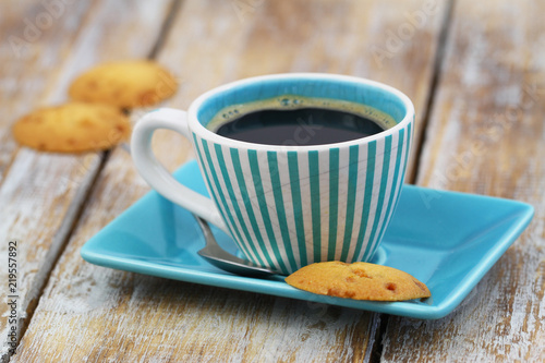 Cup of black coffee in vintage cup with a delicious, crunchy caramel cookie
