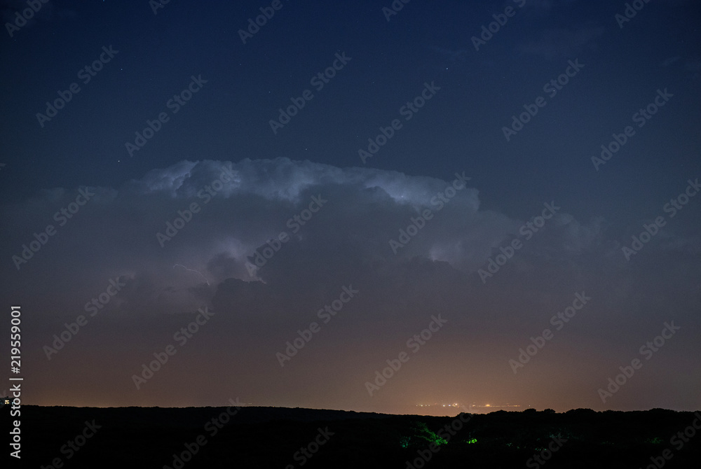 Thunderstorm clouds at night with lightning
