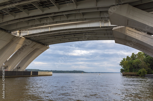 Below the Woodrow Wilson Memorial Bridge, which spans the Potomac River between Alexandria, Virginia, and the state of Maryland, as seen from Jones Point Park in Alexandria.