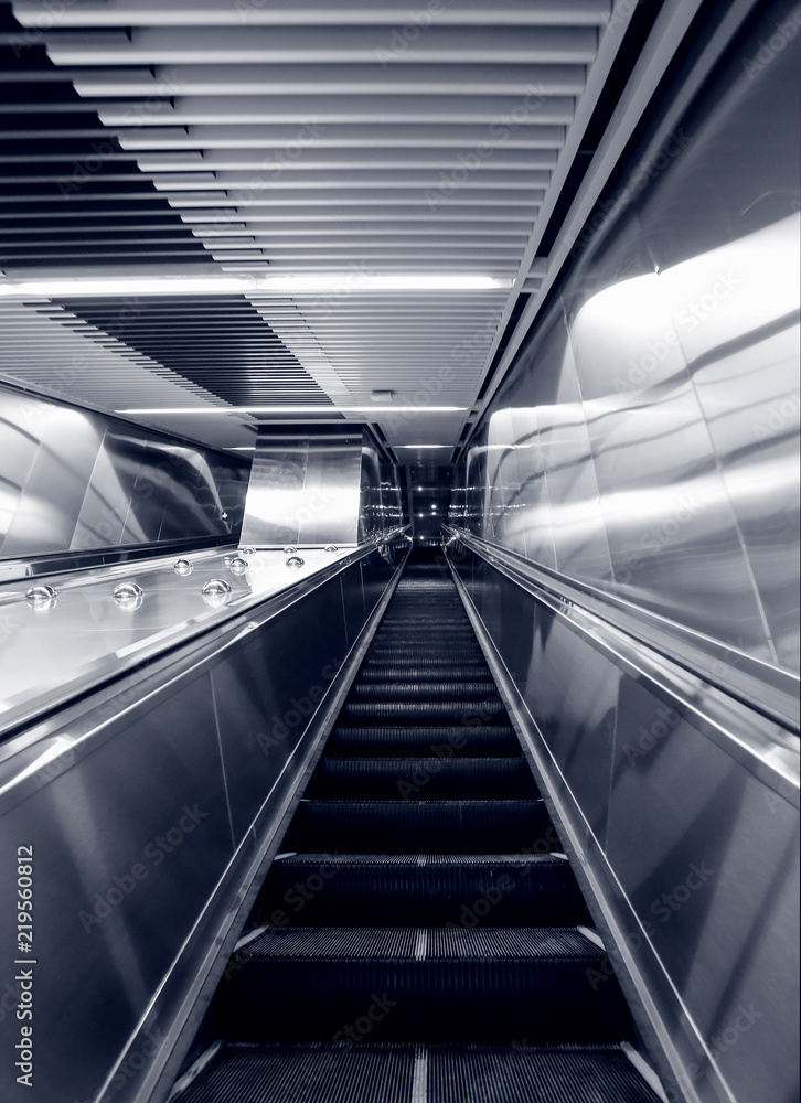 Escalator in the city leading to the underground passage of the subway Escalator in the city leading to the underground passage of the subway