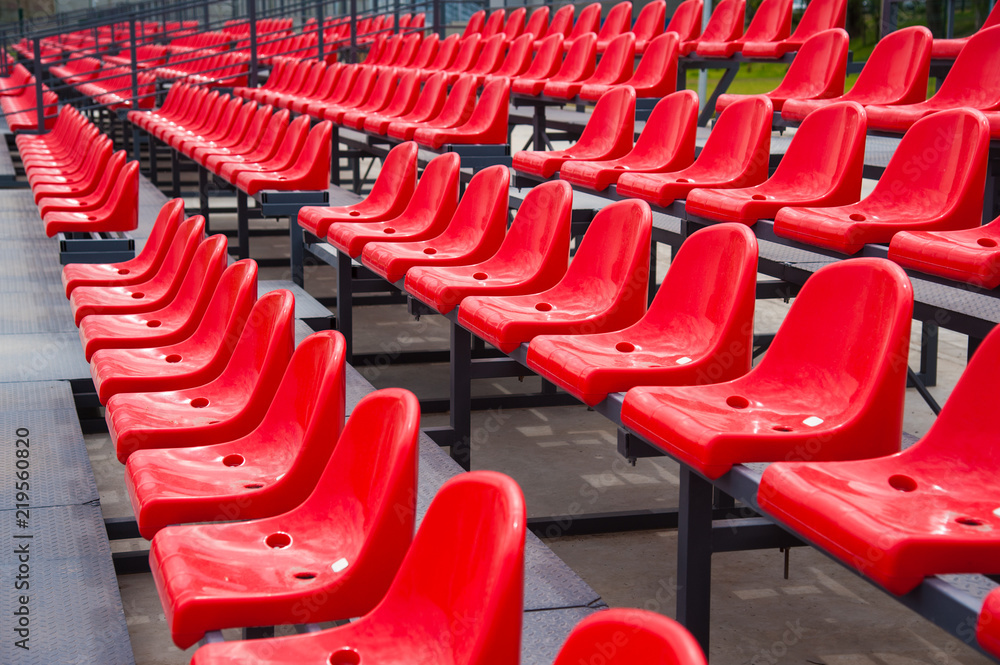 Empty red seats in stadium Empty red seats in stadium