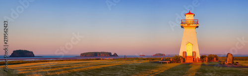 Fotografiet Lighthouse during sunrise at Five Islands, Nova Scotia.