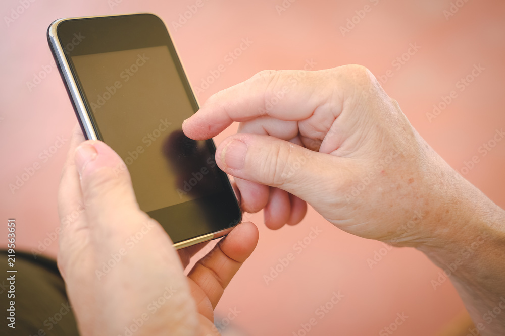 woman holding mobile phone. hand texting message, using app with smartphone outdoor