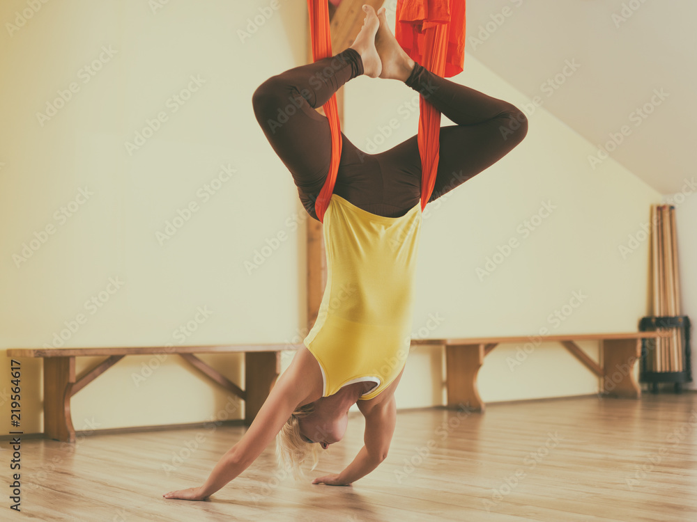 Fototapeta premium Woman doing aerial yoga in the fitness studio.