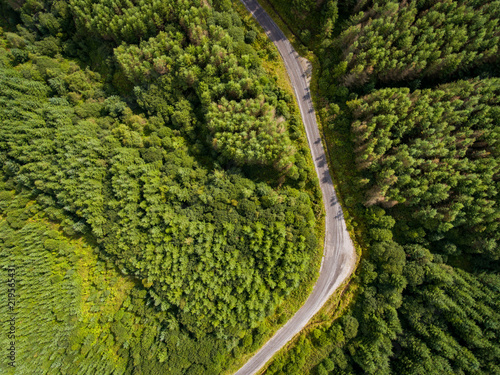 Overhead aerial view of a road running through a forest in South Wales UK