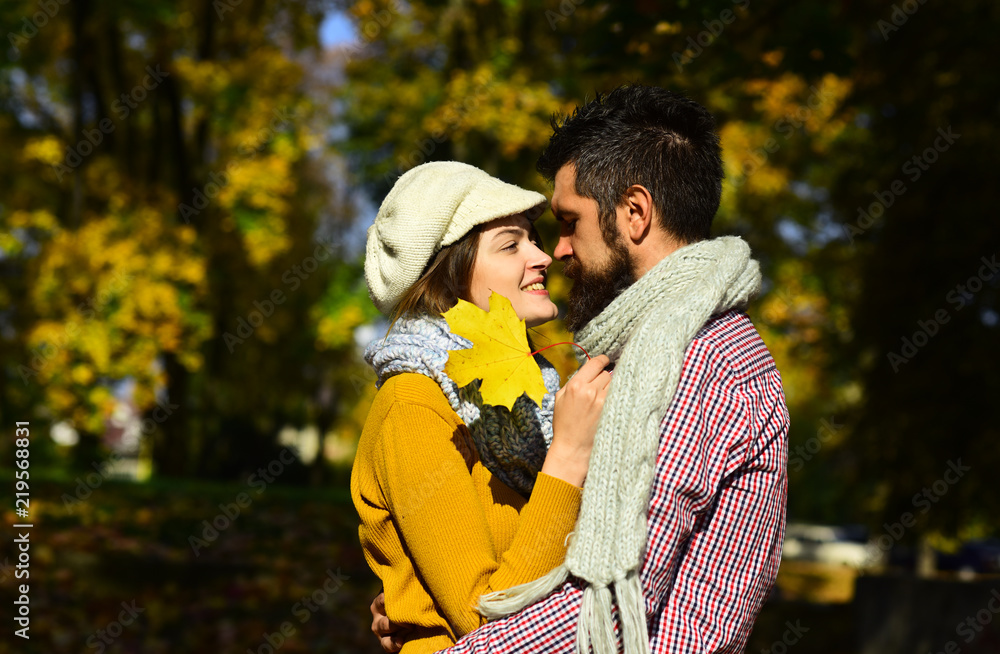 Fototapeta premium Man and woman with happy faces on autumn trees background