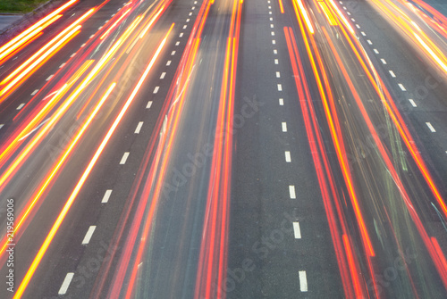 The lights of passing cars in a big avenue.