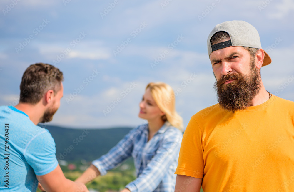 Guy adult still lonely while friends happy family life. No romantic in his life. Hipster sad face in front of couple in love. Man hipster feels lonely couple dating behind him. Unlucky romantic life Guy adult still lonely while friends happy family life. No romantic in his life. Hipster sad face in front of couple in love. Man hipster feels lonely couple dating behind him. Unlucky romantic life