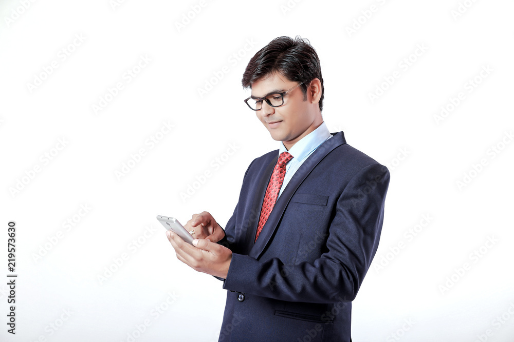 Young Indian businessman holding mobile in hand Young Indian businessman holding mobile in hand