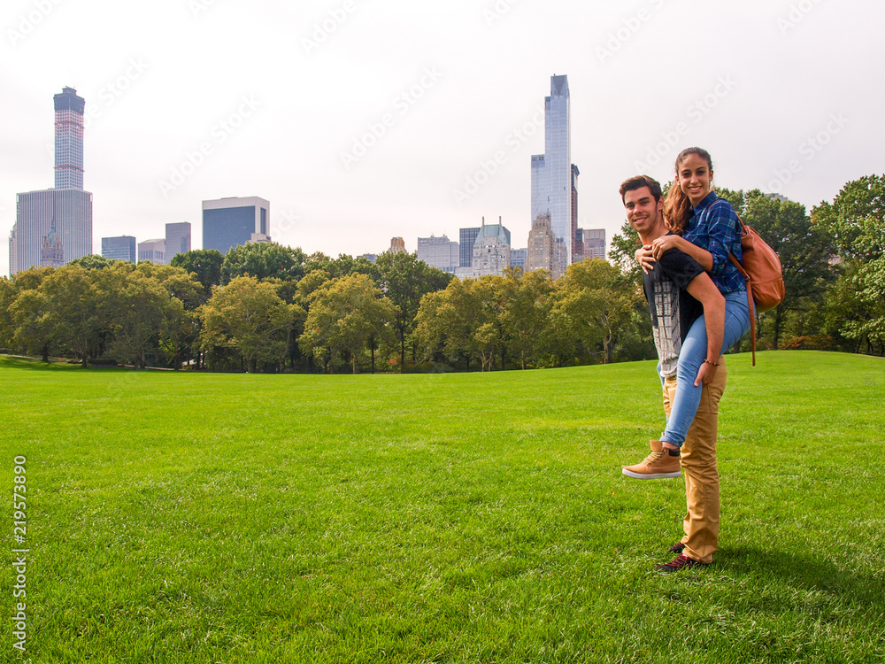 A young couple posing at Sheep Meadow in Central Park, NY, New York, USA.