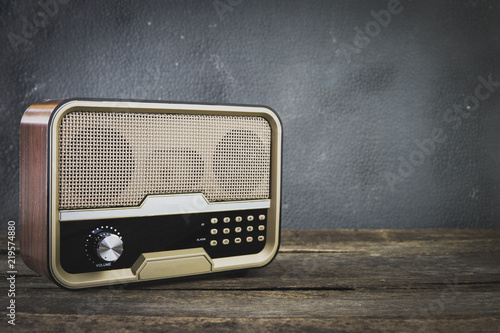 Old retro radio with on table front gray background