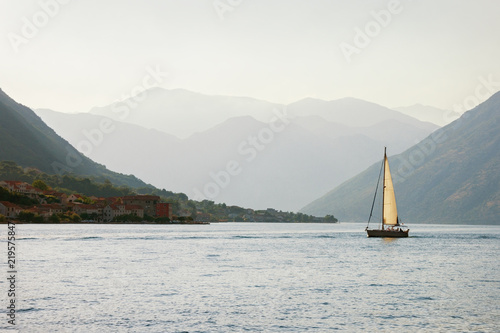 Mediterranean landscape. Sailboat sails near shore of Bay of Kotor, Adriatic Sea . Montenegro. Travel concept