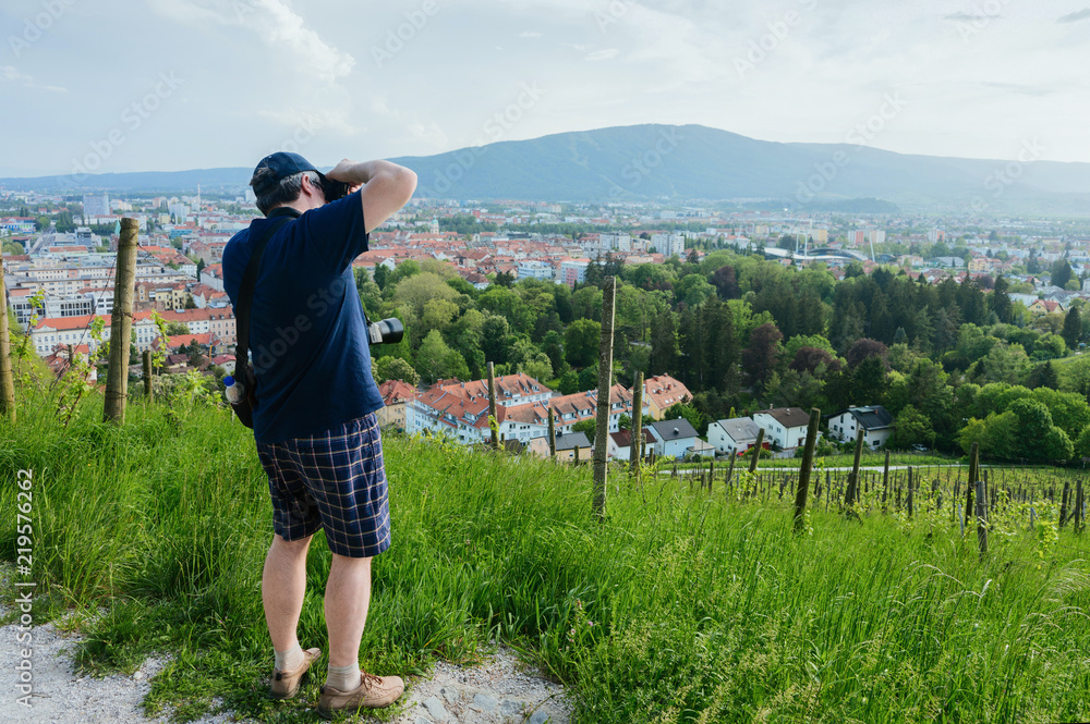 Man with camera taking photos of Vineyard in Maribor Slovenia
