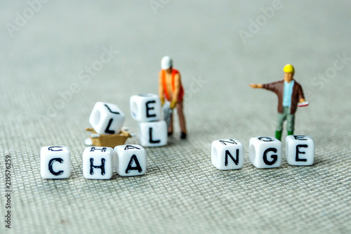 Removing white cubes with letters l and e of the word challenge creating new word change on white background with miniature figurines