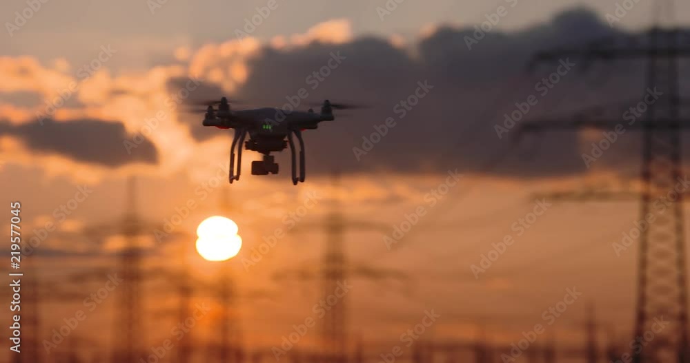 Drone flying in front of a sunset Drone flying in front of a sunset