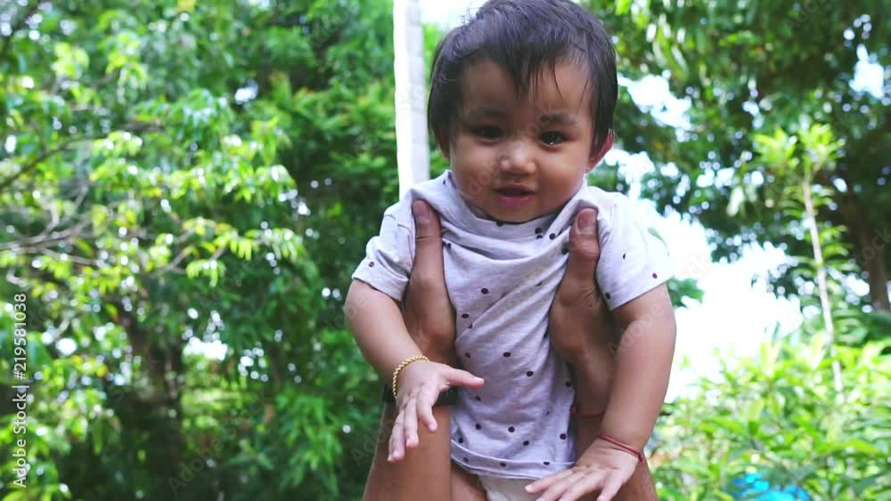 Slow Mtion: Asian girls are playing and smiling happily with his father footage Slow Mtion: Asian girls are playing and smiling happily with his father footage
