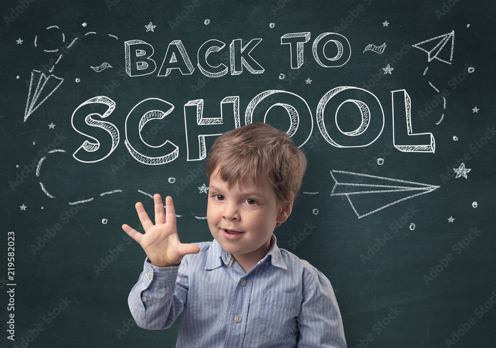 Adorable little boy with blackboard and back to school concept Adorable little boy with blackboard and back to school concept