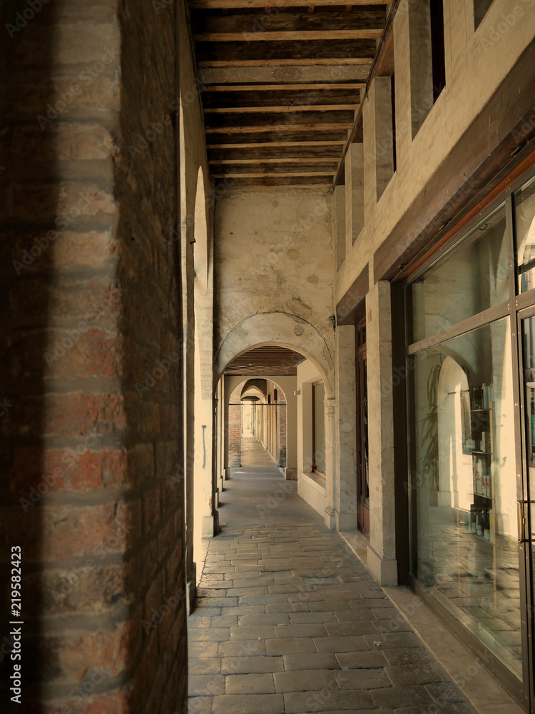 A cloistered pavement in a shopping area of Treviso Italy