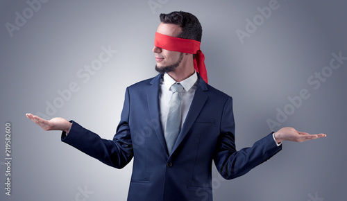 Quadro su tela Covered eye, indecisive businessman standing blind in front of a wall