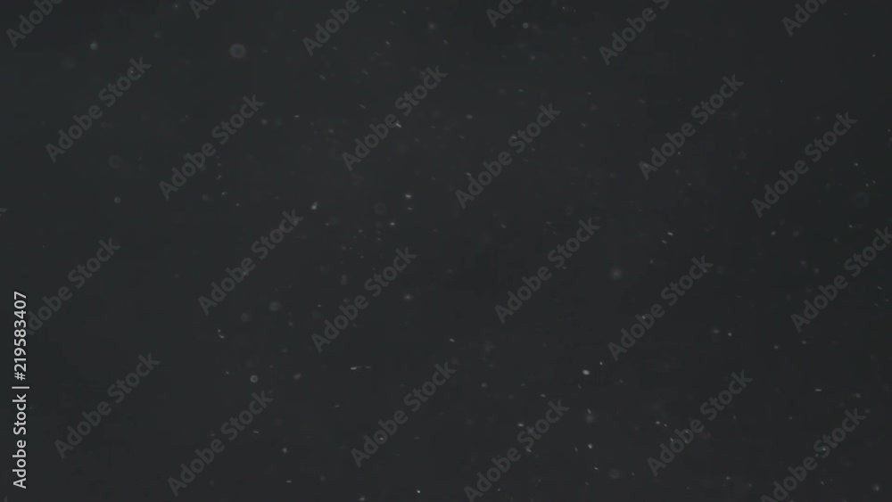 Slow motion explosion effect of dust particles on a black background Slow motion explosion effect of dust particles on a black background