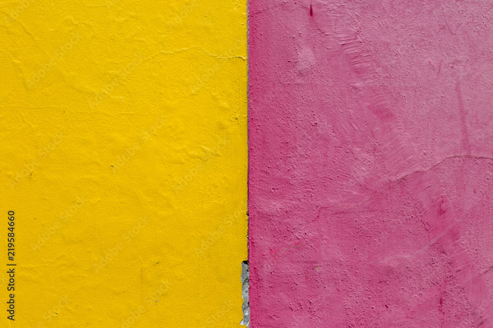 A bright yellow and pink painted wall A bright yellow and pink painted wall